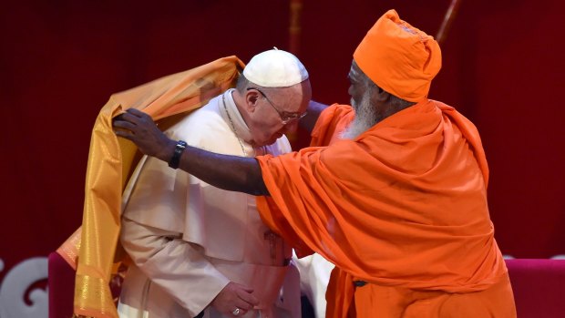Pope Francis receives a  robe from Hindu Kurukkal SivaSri T. Mahadeva during an interfaith meeting in Colombo.
