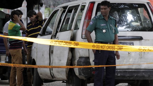 Strife torn:  Bangladeshi police set up a crime scene at the spot where Italian citizen Cesare Tavella was gunned down.