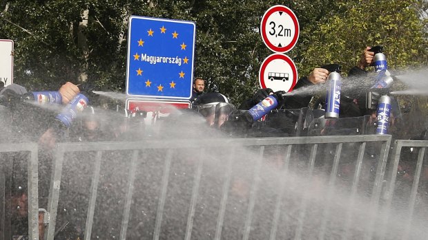 Hungarian police spraying tear gas at migrants at the 'Horgos 2' border crossing near Horgos, Serbia.