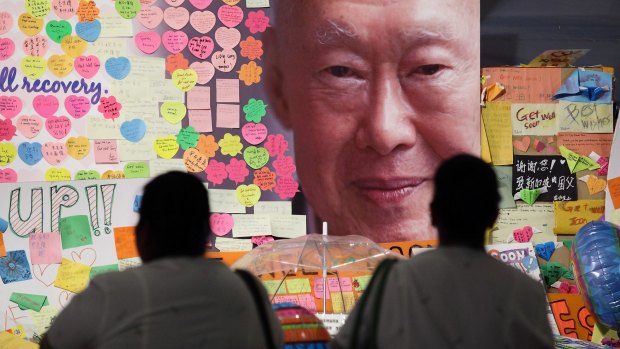 Hospital staff mourn the death of Lee Kuan Yew outside the Singapore General Hospital.