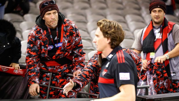 An Essendon supporter offers encouragement to coach James Hird after his team was thrashed by Adelaide.