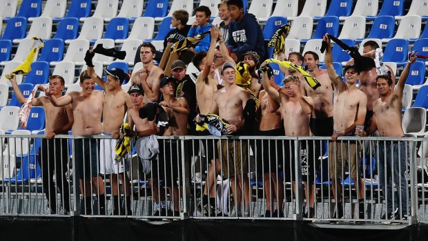 Wellington Phoenix fans take their shirts off during the round nine match against Melbourne Victory.