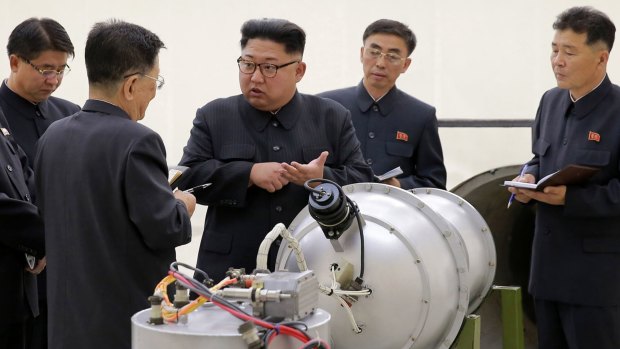 North Korean leader Kim Jong-un, centre, talks to scientists at an undisclosed location in North Korea.  