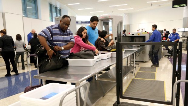 Passengers pass through security screening at Los Angeles International Airport.