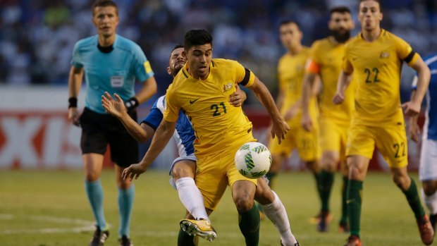 Australia's Massimo Luongofights for the ball with Honduras' Alfredo Mejia.