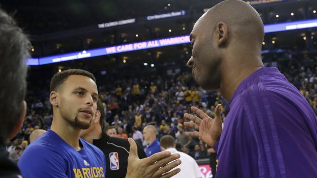 Master and apprentice: Warriors guard Stephen Curry, left, greets Lakers guard Kobe Bryant. 