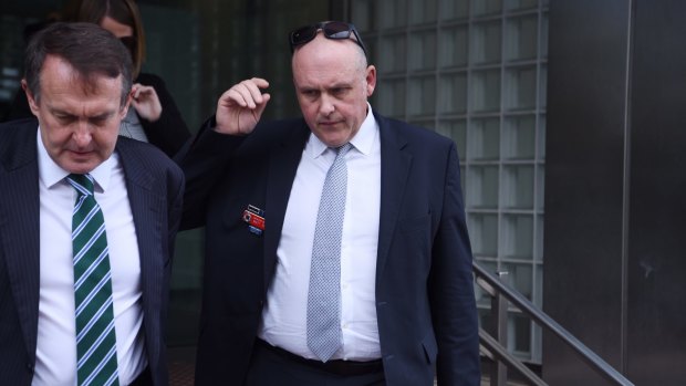 Detective Inspector Matt Kehoe, right, leaves the NSW Coroner's Court on Wednesday.