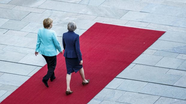 German Chancellor Angela Merkel and British Prime Minister Theresa May review a guard of honour upon May's arrival in Berlin.