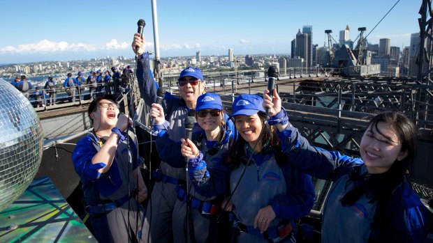 On top of the world: Chinese tourists will be able to ring in the start of their new year by singing karaoke on the summit of the Sydney Harbour Bridge.
