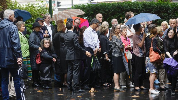 Crowds gather at the memorial service for Bill Leak at Sydney Town Hall.