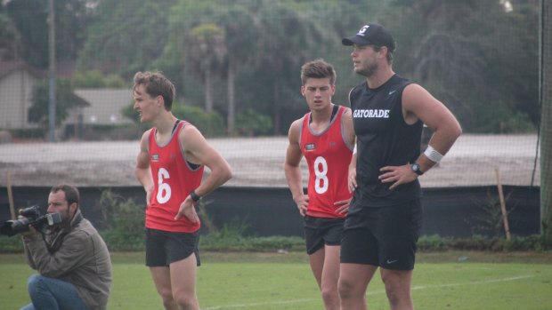 Tom Hawkins watches training.