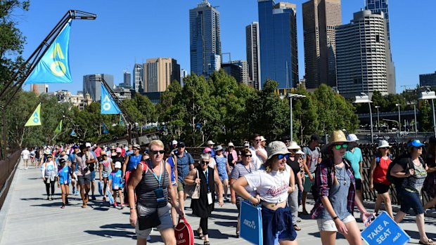 Spectators walk on the new Tanderrum Bridge on day one of the Open.