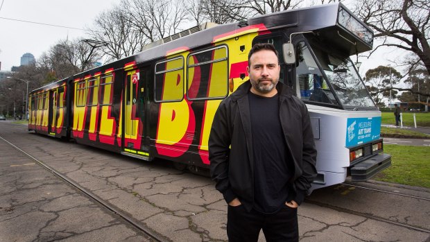 Reko Rennie with his work Always Was Always Will Be on an ''art tram'' for Melbourne Festival.