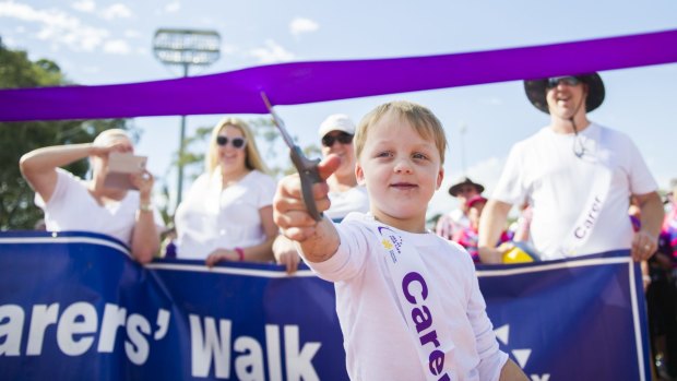 Ben Woodhams, 5, who lost his brother earlier in the year, cuts the ribbon to start the Relay for Life. 