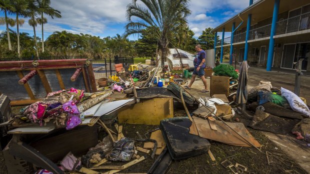Volunteer Alan Dear helps clean up a property at Eagleby damaged by flood water.