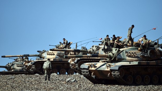 Turkish tanks line up on a hill overlooking the Syrian city of Kobane, near the Turkish border. 