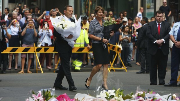 Prime Minister Tony Abbott and his wife Margie pay their respects to the victims of the Martin Place siege.