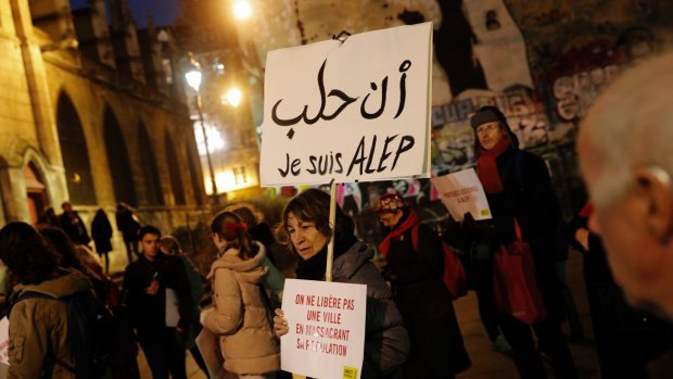 A woman holds a poster reading "I'm Aleppo" during a gathering to show support for Aleppo citizens in Paris on Wednesday.