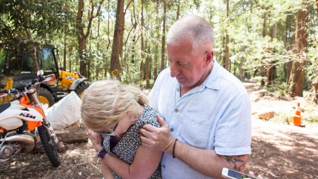 Mark Leveson comforts his wife, Faye, as the search for their son Matthew's body in the Royal National Park is called off.