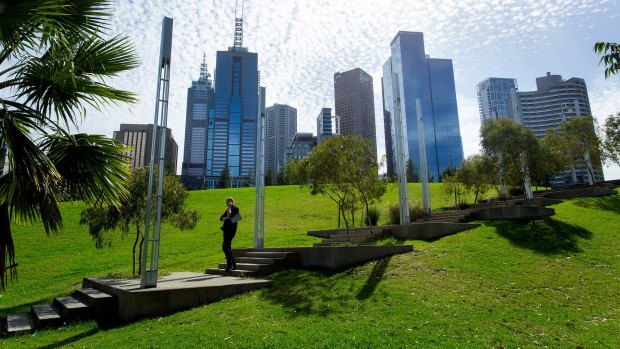 The city skyline towers over Birrarung Marr. 