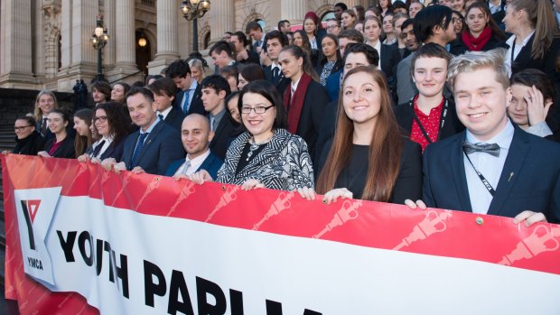 Youth Affairs Minister Jenny Mikakos (front row, third from right) and Youth Governor Caitlin Meyer (front row, second right) join the crowd at Parliament House.