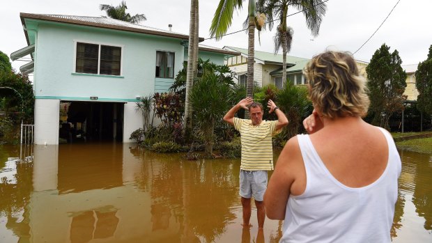 Tracey (right) and Laurie Batshaw (left) in front of their house in flooded Bright street in Lismore. 