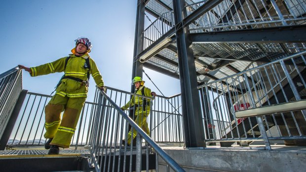 ACT Firefighters Matt Buchtmann and Kari Harlovich are among five ACT firefighters who will be running up and down Sydney Tower in their full gear to raise money and awareness for Motor Neurone Disease. They are training at the Hume training facility.