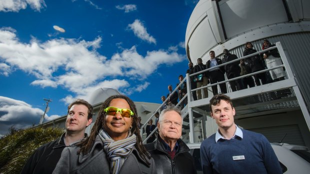 Researchers Paul Sibley, Moriba Jah, Ben Greene and Michael Copeland gather in front of Mount Stromlo's satellite laser station. 