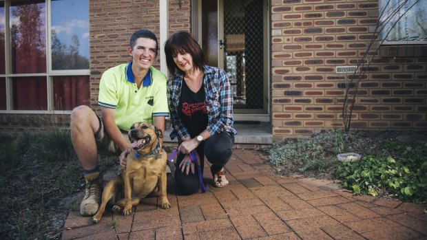 An amazing random act of kindness - Canberra tradie Josh Lancaster with Pumpkin the staffy and her owner, Jenny Spear, of Wanniassa.