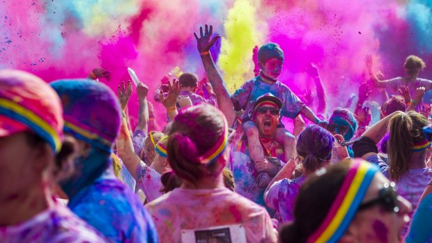 Todd and Logan Berry, 6, in the action from the Colour Run in Canberra.
