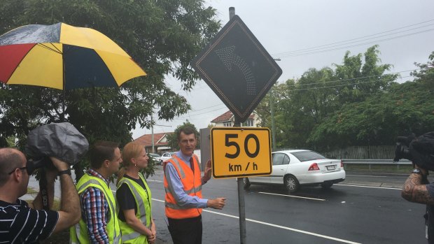 Lord Mayor Graham Quirk, at Old Cleveland Road, Camp Hill, turns on one of the LED street signs.