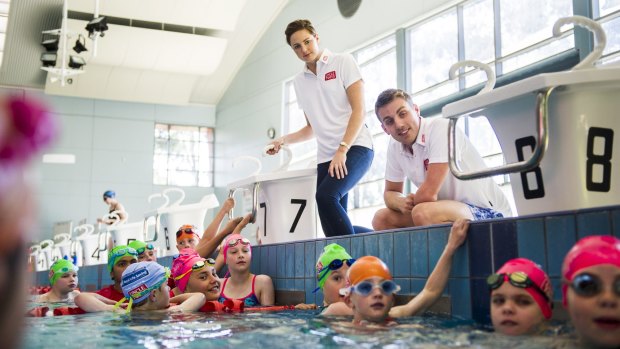 Olympians Cate Campbell and Matt Cowdrey give kids at the Tuggeranong pool a few tips.