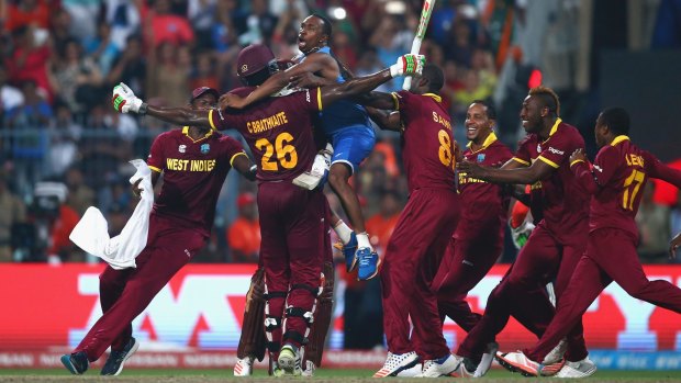 World champions: West Indies players celebrate victory after Carlos Brathwaite hit the winning runs in the final against England in Kolkata last April.