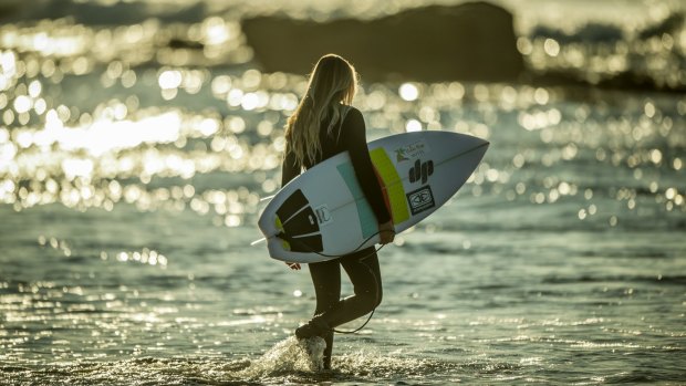 Sophia Fulton, 15, takes to the water under the watchful eye of coach and mentor surfing legend Pam Burridge.