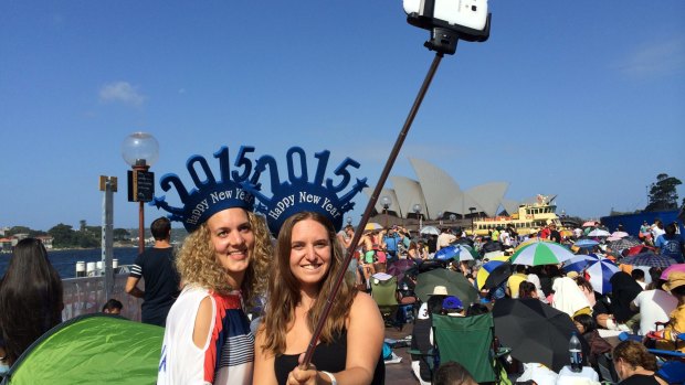 Lisa Gelz and Isabelle Horber, tourists from Switzerland, finding the best angles with their selfie stick.