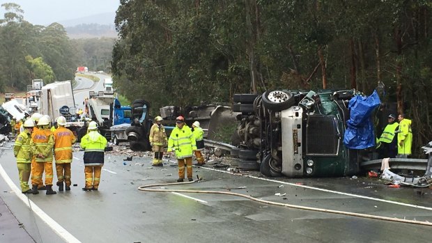 The scene of the accident involving two trucks and a car towing a caravan on the Pacific Highway near Taree on Thursday.