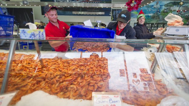 Customers flock to the Fyshwick FishCo Market to stock up on seafood for Christmas. 