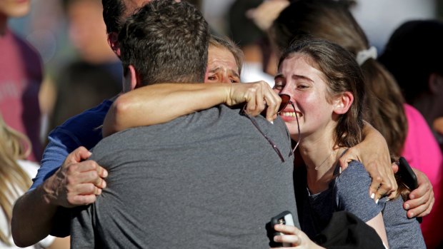 A family reunites following the shooting at Marjory Stoneman Douglas High School.