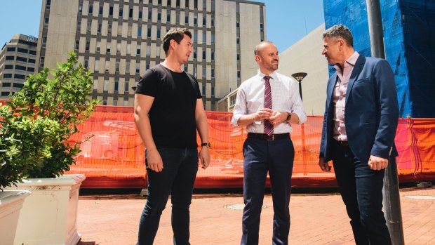Crafted's Matt James, left, and Peter Sarris, right, discuss the new development with Chief Minister Andrew Barr onsite in London Circuit.