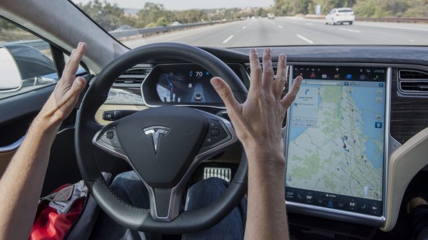 No hands ... test-driving an automated Tesla Motors Inc. Model S car.