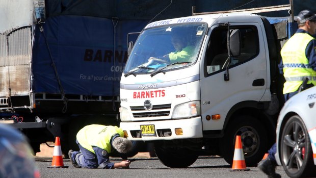 Police check trucks belonging to Barnetts Couriers on Friday.