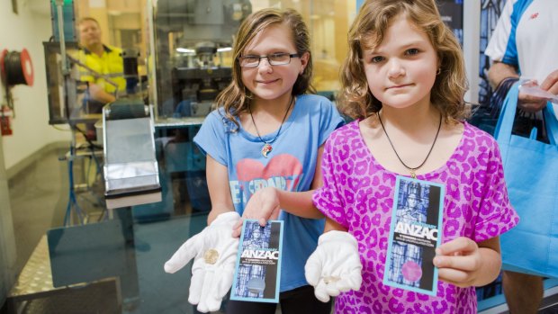 Sisters Emalee Olbrich (left), 11, and Chelsea Olbrich, 8, travelled to Canberra from Sydney to receive one of the first coins minted at the Royal Australian Mint for 2015.