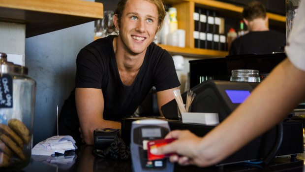 Kingston's TwoforJoy staff member Luka Markulin and a customer using a contactless payment option.