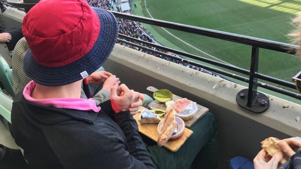 A man who sent social media into meltdown by feasting on an extravagant cheese platter while watching an AFL match at the MCG has broken his silence.