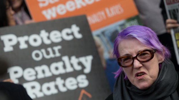 Hospitality and aged care worker Maire O'Connor protests on Collins Street, Melbourne.