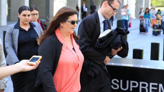Banned greyhound trainer Deborah Arnold, husband Steven and her legal team leave the Brisbane Supreme Court on Friday.