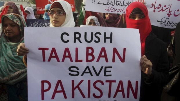 Protesters condemn the Taliban attack on a military-run school in Peshawar.