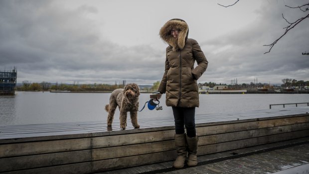 Sarah-Jane Dartnell, of Kingston Foreshore, braved Monday's big wet with her dog Migo.