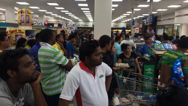 People queue in a supermarket in Suva ahead of Cyclone Winston's landfall. 
