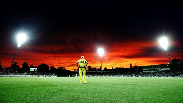 Picturesque: James Faulkner of Australia fields near the boundary rope as the sun sets in Canberra.